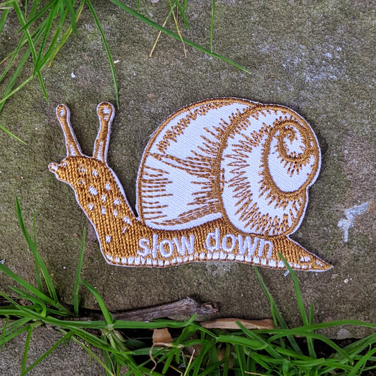 iron-on patch | slow down snail - brown 1.6" x 2.6"