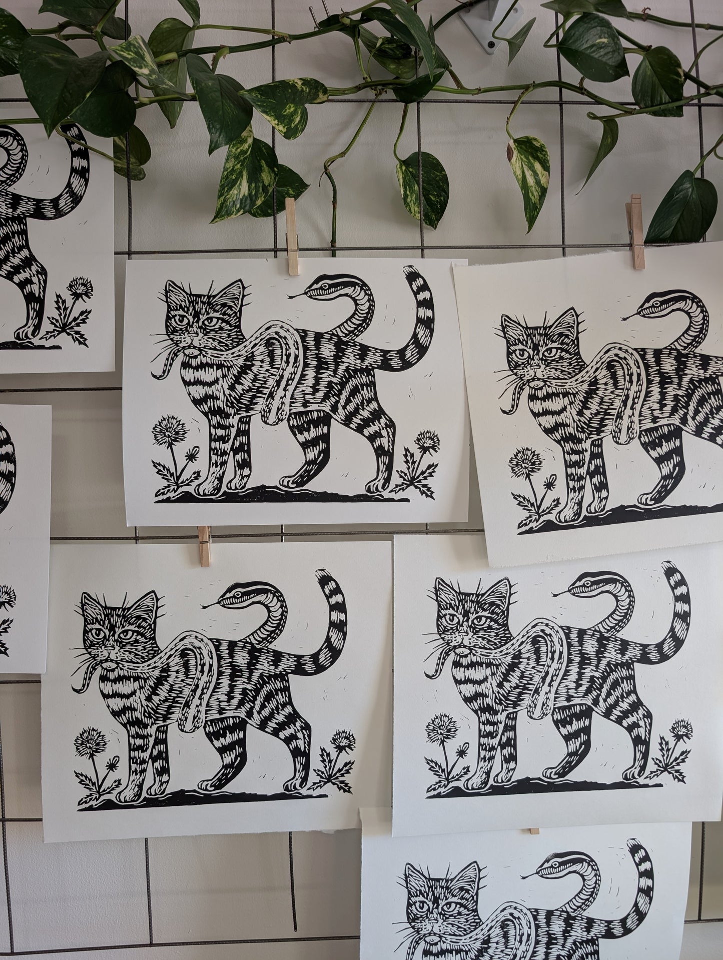 handprinted blockprint | caught (snake coiled around cat)