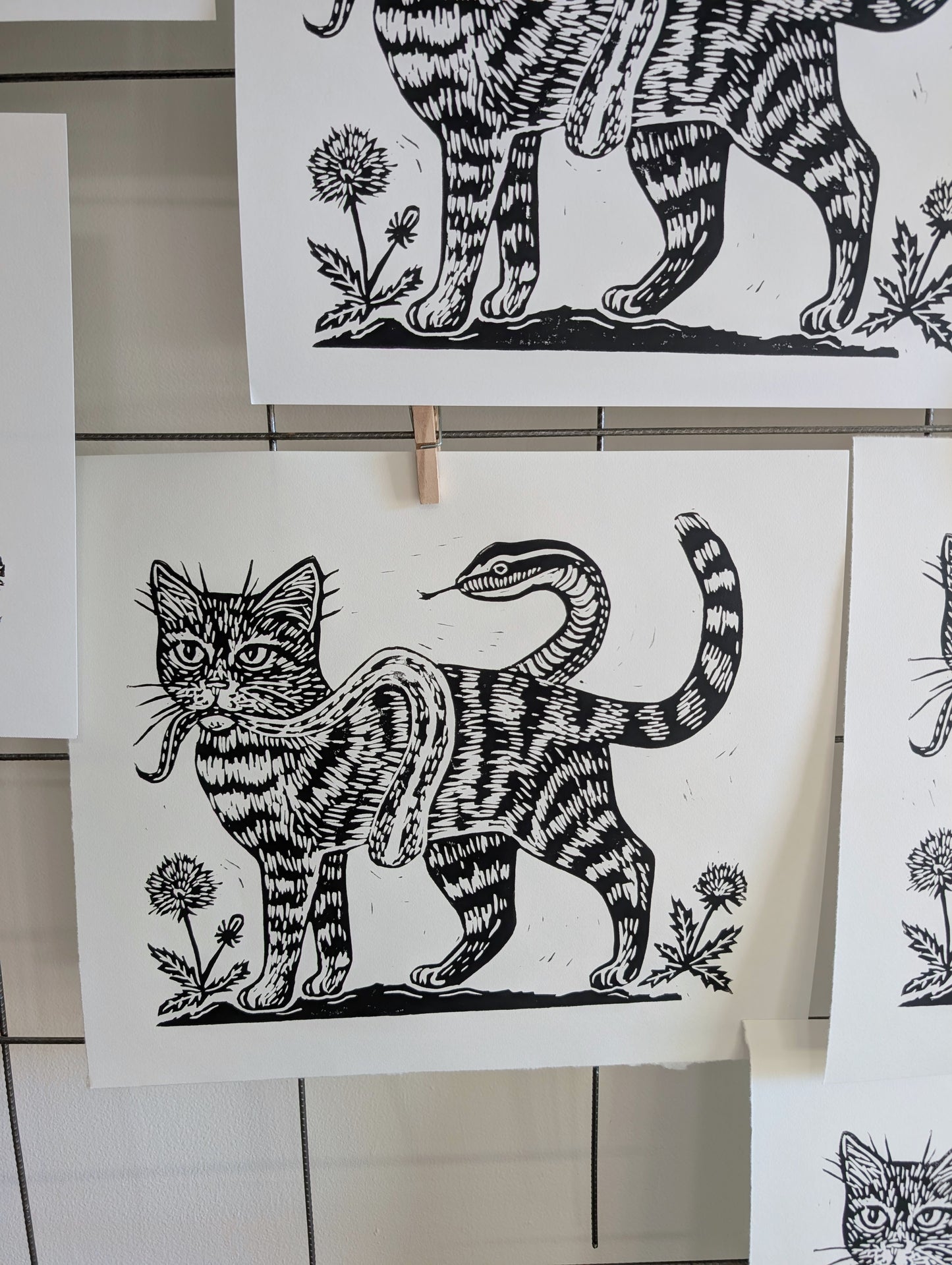 handprinted blockprint | caught (snake coiled around cat)
