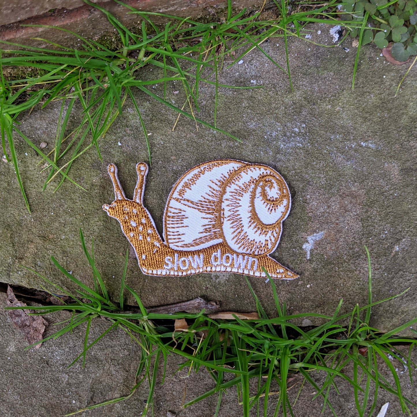 iron-on patch | slow down snail - brown 1.6" x 2.6"